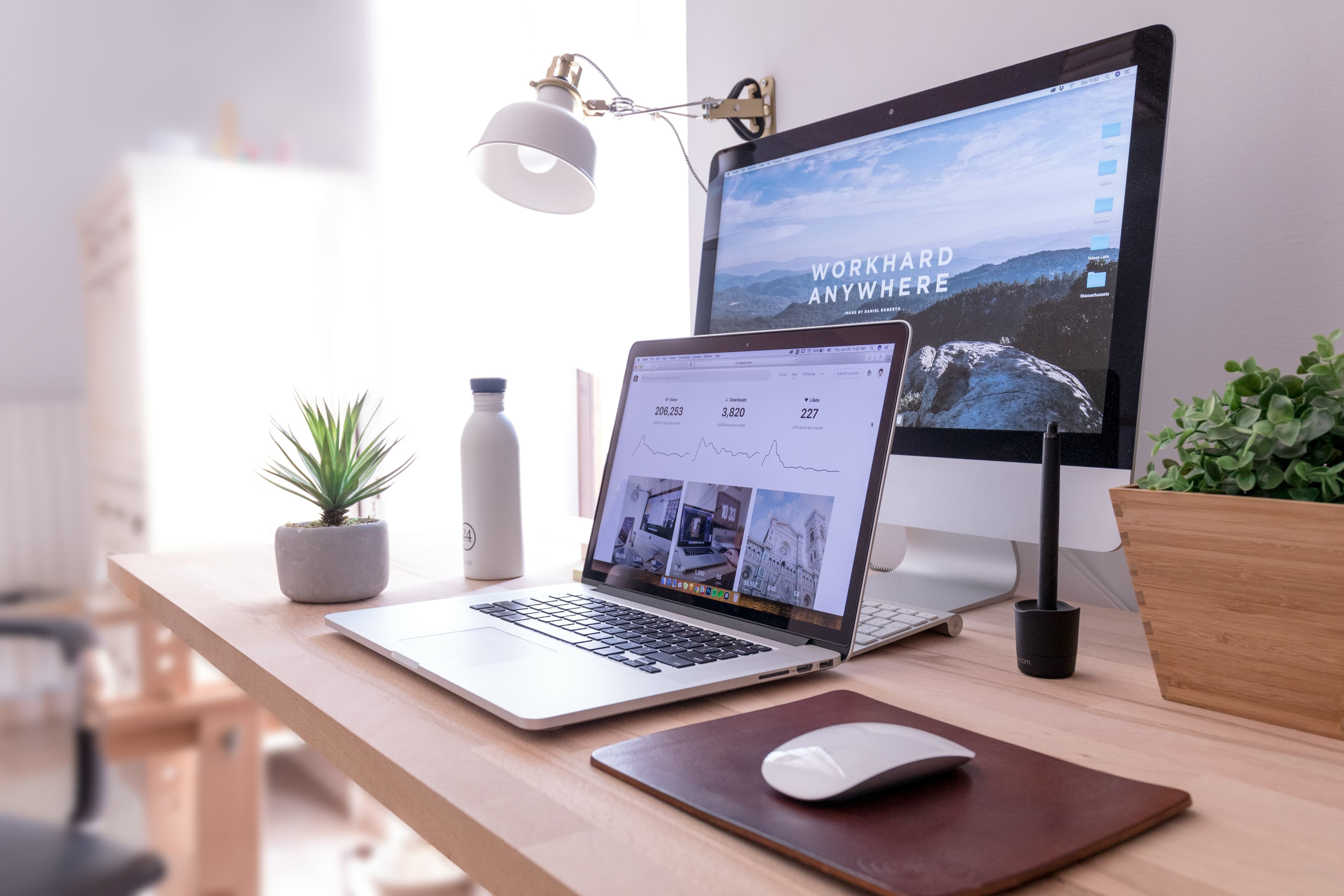 Heldere werkplek met desktopmonitor en laptop voor webdesignwerk